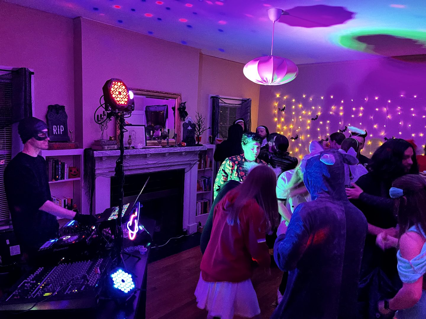 Party guests and DJ lighting in a cozy indoor venue